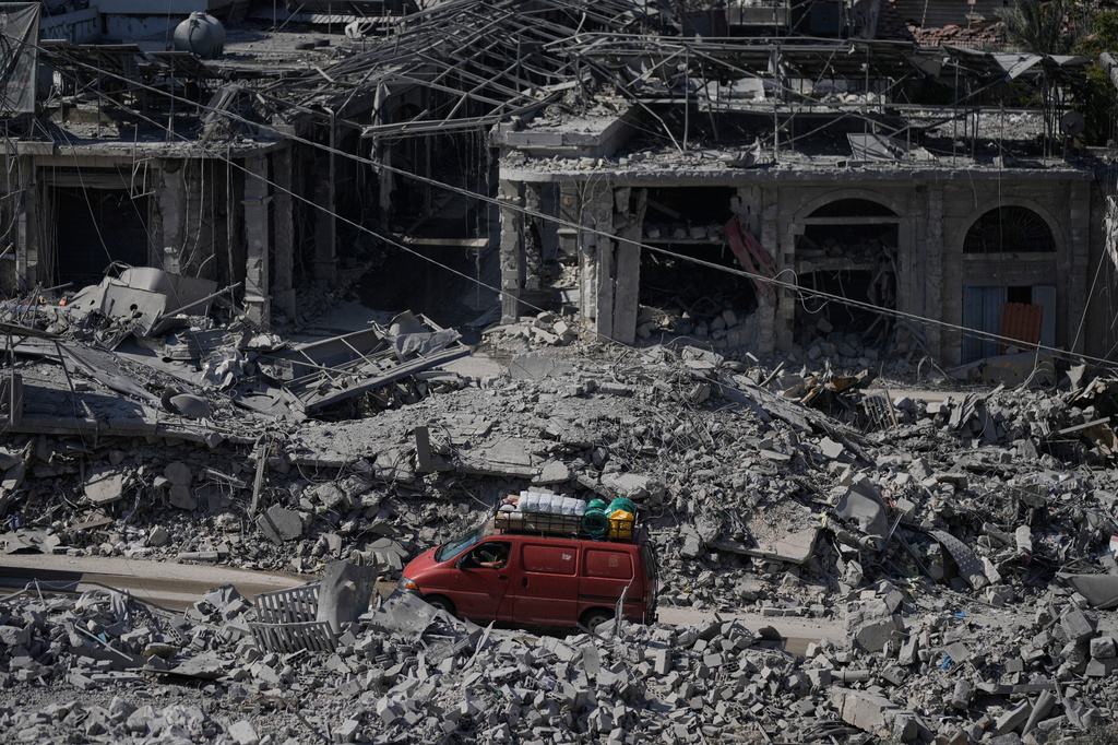 FILE - Residents drive past buildings destroyed in Israeli airstrikes in the town of Nabatiyeh, southern Lebanon, June 24, 2026. (AP Photo/Bilal Hussein, File)