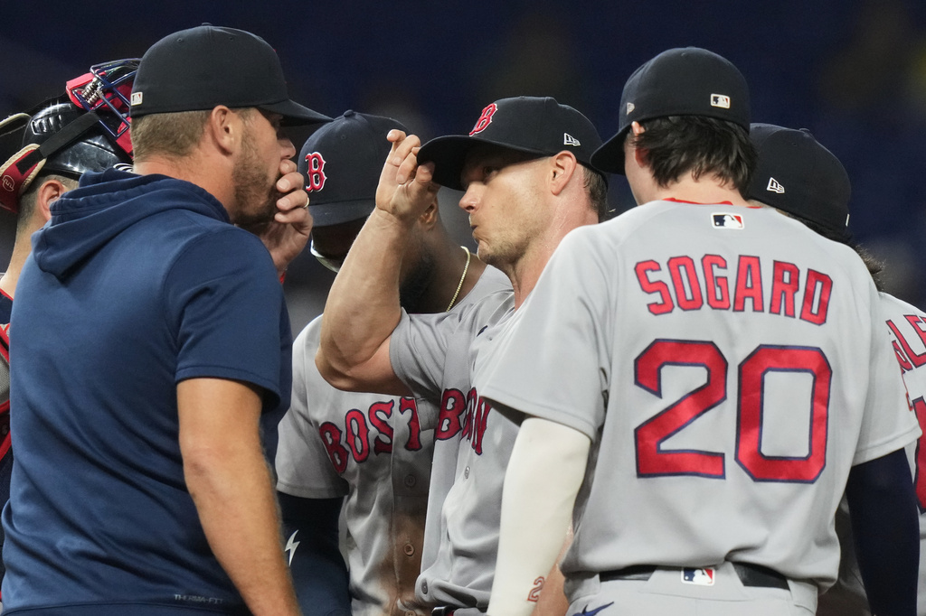 Boston Red Sox starting pitcher Sonny Gray, center, talks on the mound during the second inning of a baseball game against the Miami Marlins, Wednesday, Aug. 26, 2026, in Miami. (AP Photo/Lynne Sladky)