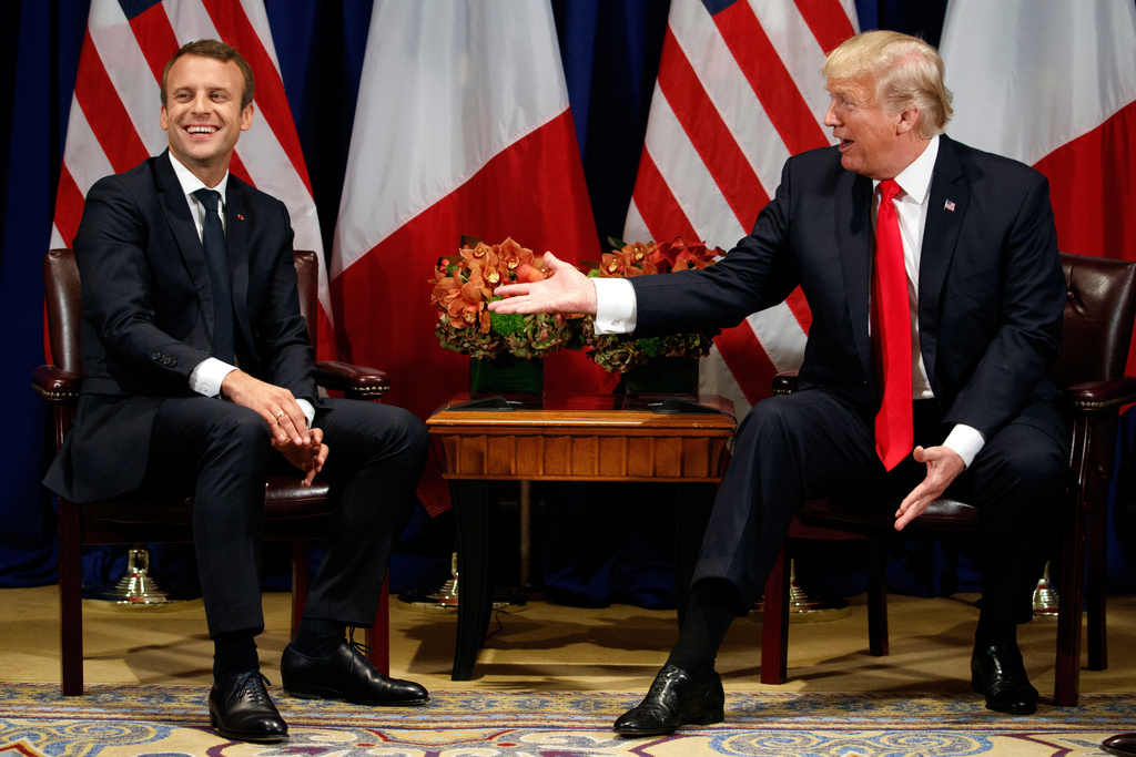FILE - President Donald Trump jokes with French President Emmanuel Macron during a meeting at the Palace Hotel during the United Nations General Assembly, Sept. 18, 2017, in New York. (AP Photo/Evan Vucci, File)