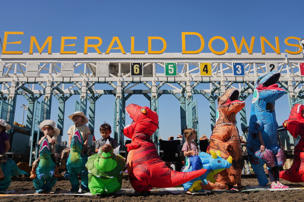Young racers prepare at the starting gate before a kids' heat during the T-Rex World Championship Races at Emerald Downs, Sunday, July 12, 2026, in Auburn, Wash. (AP Photo/Lindsey Wasson)