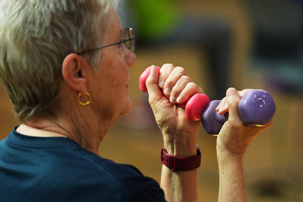 FILE - A participant uses light weights during a class for older adults at the Dale Turner Family YMCA in Shoreline, Wash., April 30, 2026. (AP Photo/Lindsey Wasson, File)