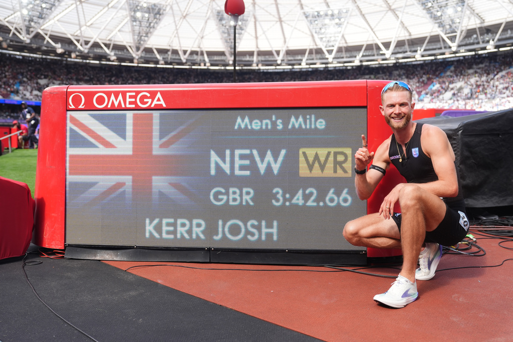 Britain's Josh Kerr celebrates after winning and breaking a world record in the Men's 1 Mile final during the Novuna London Athletics Meet at the London Stadium, Saturday July 18, 2026. (Adam Davy/PA via AP)