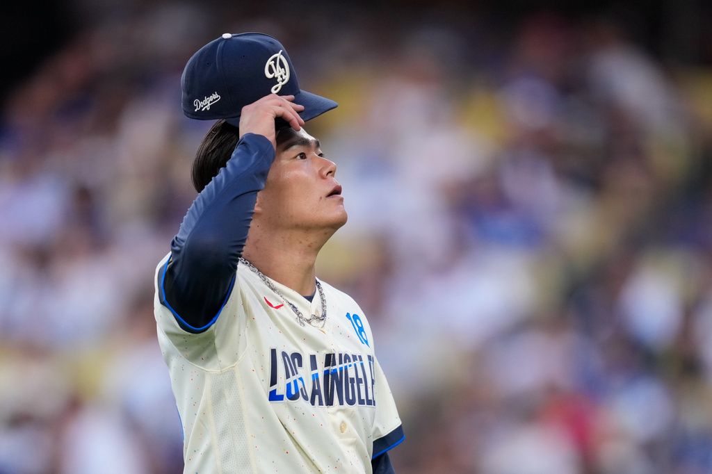 Los Angeles Dodgers pitcher Yoshinobu Yamamoto wipes adjusts his cap after finishing the top of the fifth inning of a baseball game against the Arizona Diamondbacks, Saturday, July 11, 2026, in Los Angeles. (AP Photo/Mark J. Terrill)