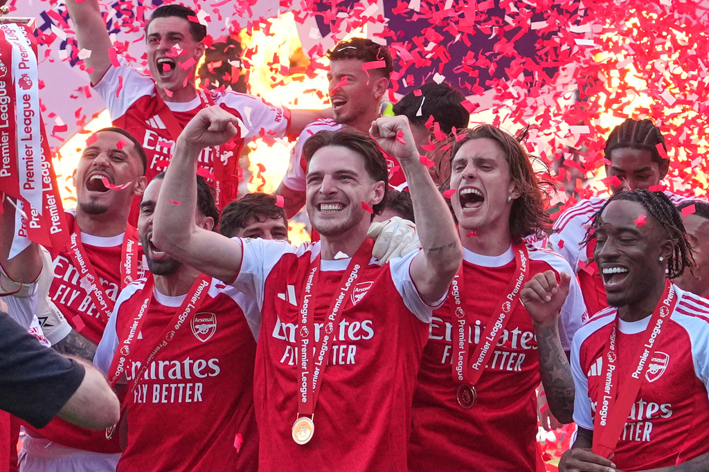 Arsenal players celebrate their Premier League title with the trophy after the English Premier League soccer match between Crystal Palace and Arsenal in London, England, Sunday, May 24, 2026. (AP Photo/Kin Cheung)