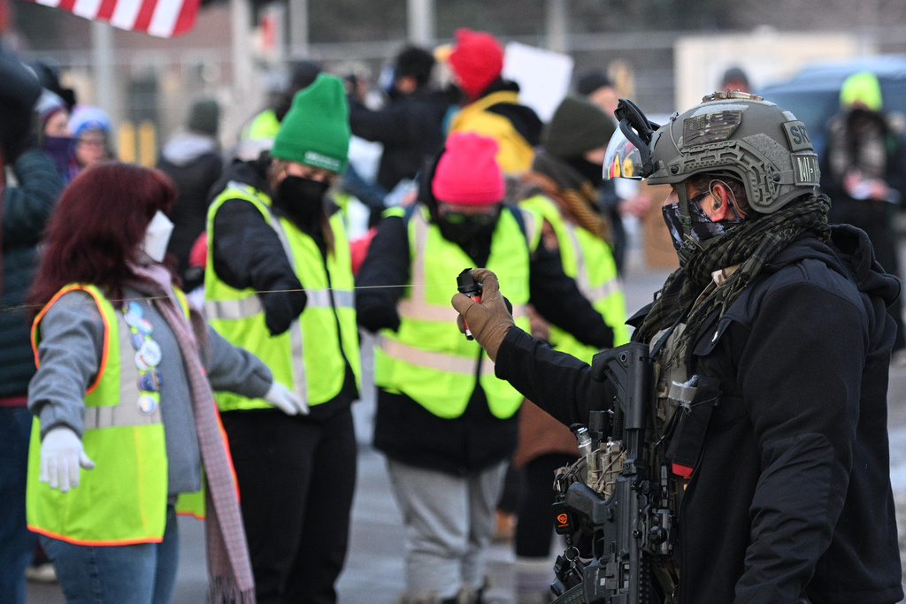 Law enforcement uses a chemical agent on protesters outside the Bishop Henry Whipple Federal Building, Thursday, Jan. 8, 2026, in Minneapolis, Minn. (AP Photo/Tom Baker)