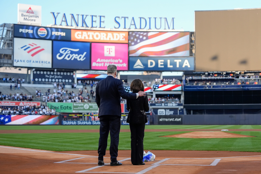 New York Yankees broadcasters Michael Kay, left, and Suzyn Waldman, right, stand during a tribute to late former Yankees broadcaster John Sterling ahead of a baseball game between the New York Yankees and the Baltimore Orioles, Monday, May 4, 2026, in New York. (AP Photo/Yuki Iwamura)