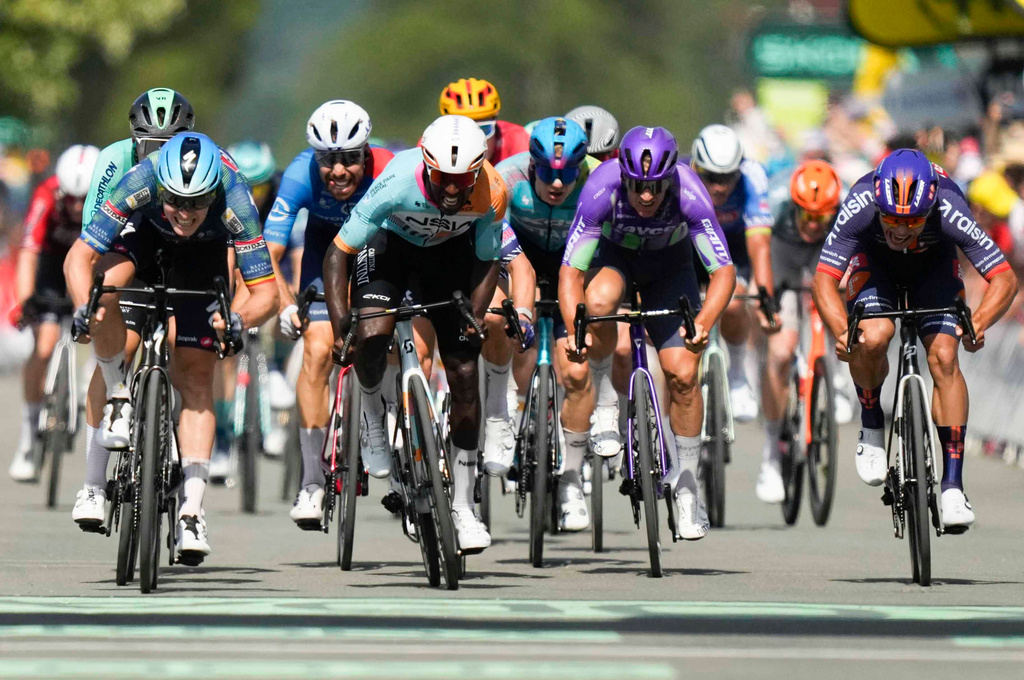 Belgium's Tim Merlier, left, crosses the finish line to win the eighth stage of the Tour de France cycling race with start in Perigueux and finish in Bergerac, France, Saturday, July 11, 2026. (AP Photo/Mosa'ab Elshamy)