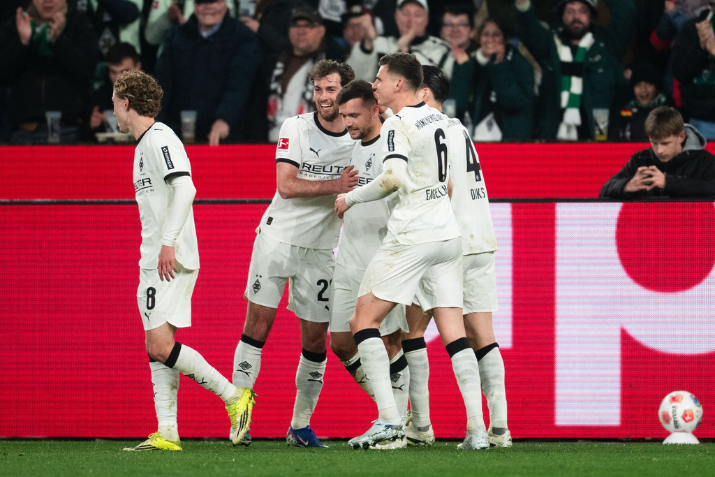 From left: Mönchengladbach's Hugo Bolin, Joe Scally, goal scorer Kevin Stöger, Yannik Engelhardt and Kevin Diks celebrate after scoring the opening goal during the German Bundesliga soccer match between Borussia Mönchengladbach and FC St. Pauli, in Mönchengladbach, Germany, Friday, March 13, 2026. (Marius Becker/dpa via AP)