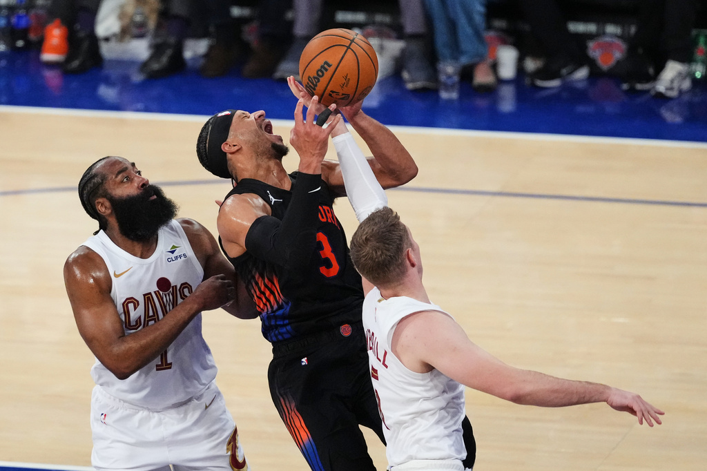 Cleveland Cavaliers' James Harden, left, and Sam Merrill defend New York Knicks' Josh Hart, center, during the second half of Game 2 in the Eastern Conference finals NBA basketball playoffs series, Thursday, May 21, 2026, in New York. (AP Photo/Frank Franklin II)