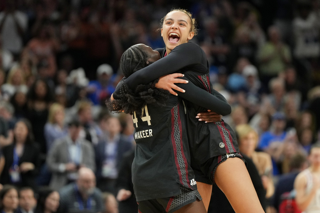 South Carolina guard Tessa Johnson, right, and South Carolina guard Agot Makeer (44) celebrate after defeating UConn in a woman's NCAA college basketball tournament semifinal game at the Final Four, Friday, April 3, 2026, in Phoenix. (AP Photo/Rick Scuteri)