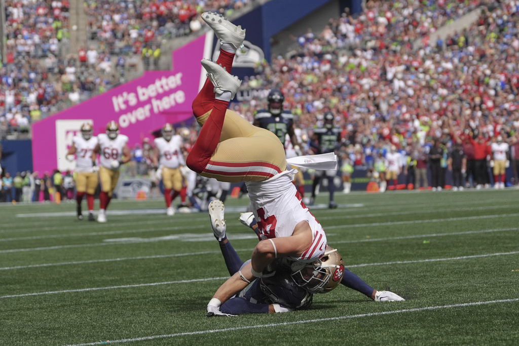San Francisco 49ers fullback Kyle Juszczyk (44) holds on the the ball while being brought down during the first half of an NFL football game against the Seattle Seahawks, Sunday, Sept. 7, 2025, in Seattle. (AP Photo/Lindsey Wasson)