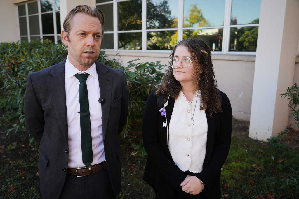 Animal rights activist Zoe Rosenberg, right, who is on trial for taking four chickens from one of Perdue Farms' major poultry plants, stands next to her attorney Chris Carraway outside Sonoma County Superior Court in Santa Rosa, Calif. on Tuesday, Oct. 28, 2025. (AP Photo/Terry Chea)
