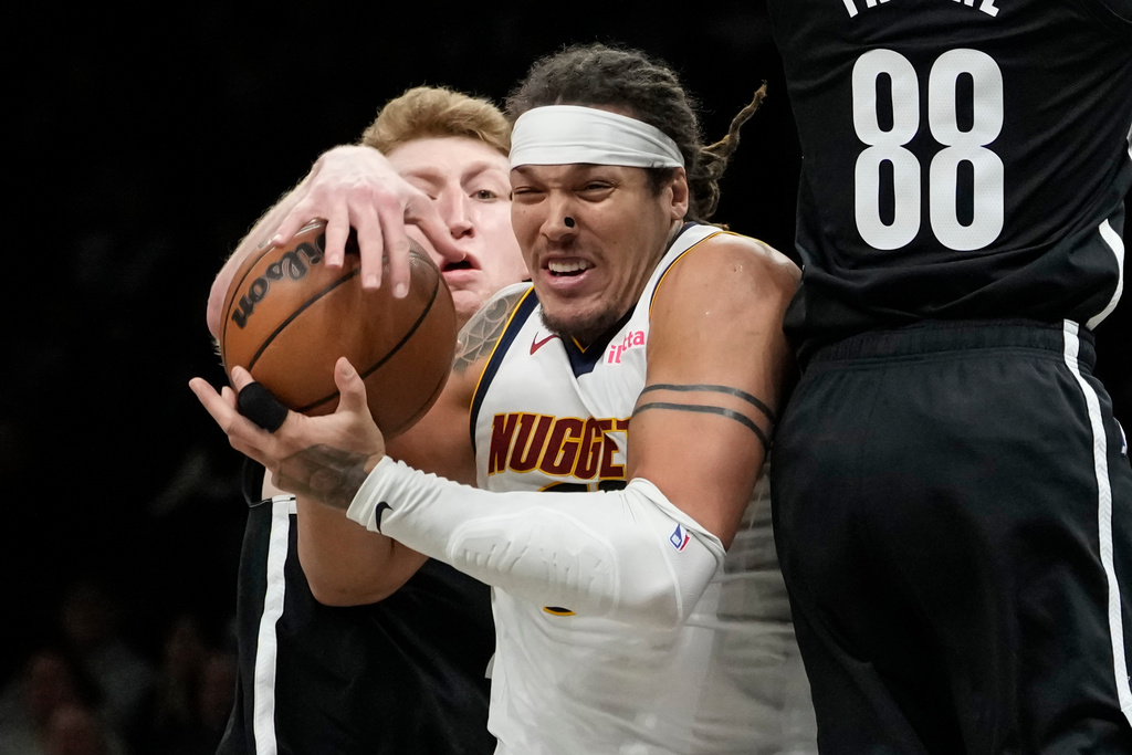Brooklyn Nets forward Danny Wolf, left, steals the ball from Denver Nuggets forward Aaron Gordon during the second half of an NBA basketball game, Sunday, Jan. 4, 2026, in New York. (AP Photo/Yuki Iwamura)