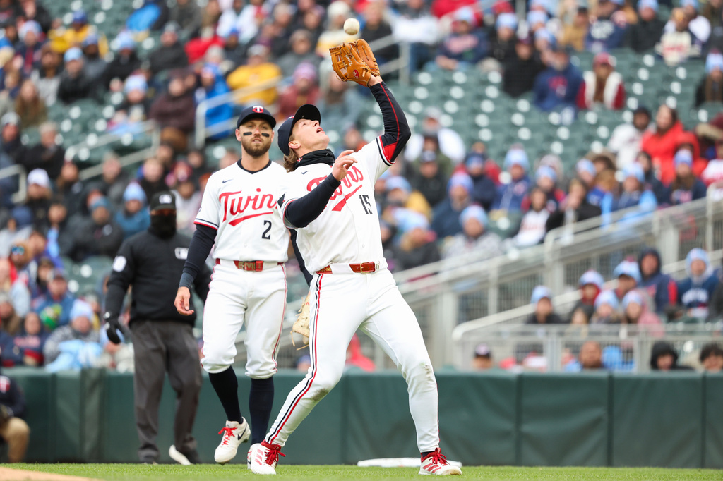 Minnesota Twins second baseman Luke Keaschall (15) catches an out on the Tampa Bay Rays while second baseman Kody Clemens looks on during the first inning of a baseball game Friday, April 3, 2026, in Minneapolis. (AP Photo/Ellen Schmidt)