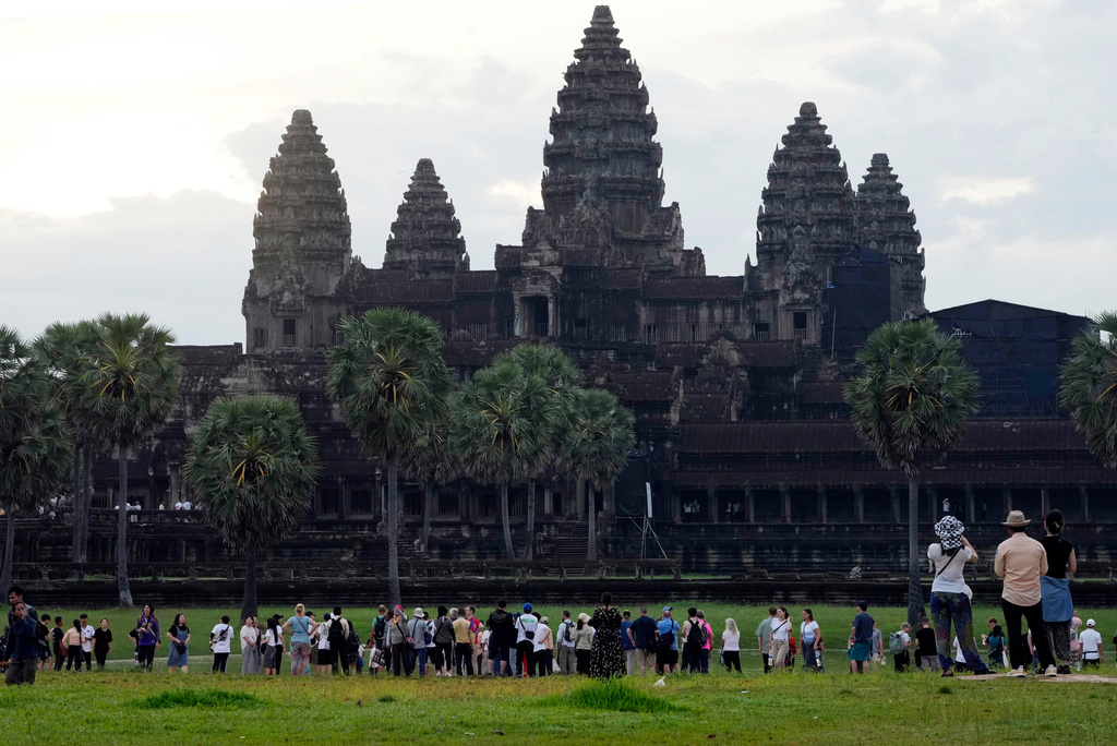 FILE - Tourists wait for sunrise at the Angkor Wat temple in Siem Reap province, Cambodia, Friday, Aug. 2, 2024. (AP Photo/Heng Sinith, File)
