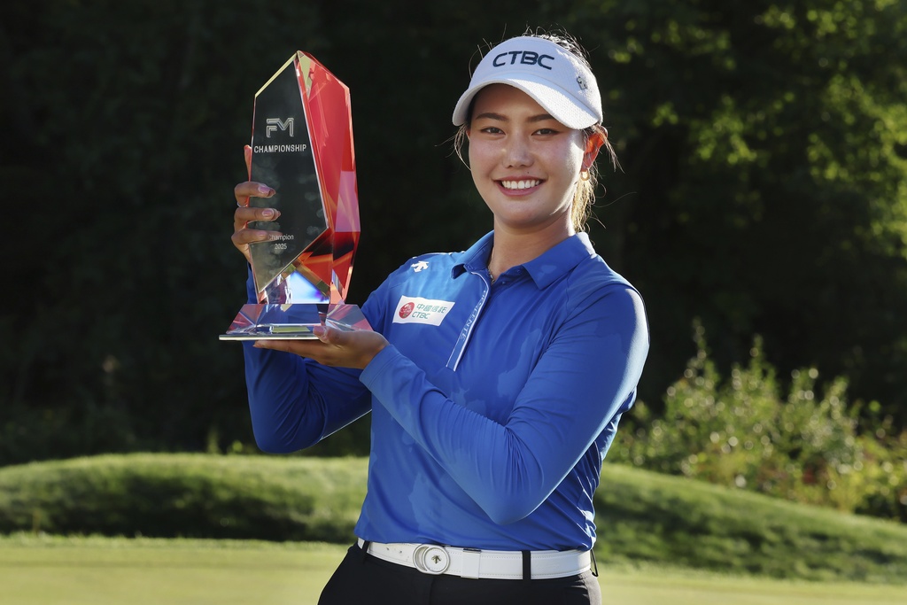 Miranda Wang, of China, holds the trophy after winning the FM Championship LPGA golf tournament at TPC Boston, Sunday, Aug. 31, 2025, in Norton, Mass. (AP Photo/Michael Dwyer)