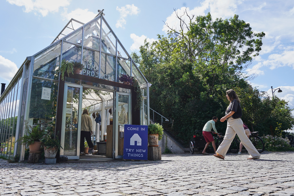 A woman enters fine-dining restaurant Noma's cafe and shop in Copenhagen, Denmark Tuesday, July 28, 2026. (AP Photo/James Brooks)