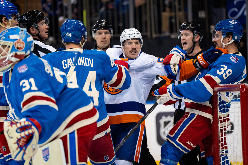 New York Islanders center Casey Cizikas fights with New York Rangers players during the first period of an NHL hockey game, Saturday, Nov. 8, 2025, in New York. (AP Photo/Angelina Katsanis)
