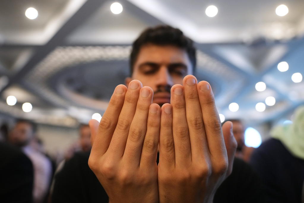 Muslim worshipper Ahmed Alkhekani attends Eid al-Fitr prayer at the Islamic Institute of America Friday, March 20, 2026, in Dearborn Heights, Mich. (AP Photo/Paul Sancya)