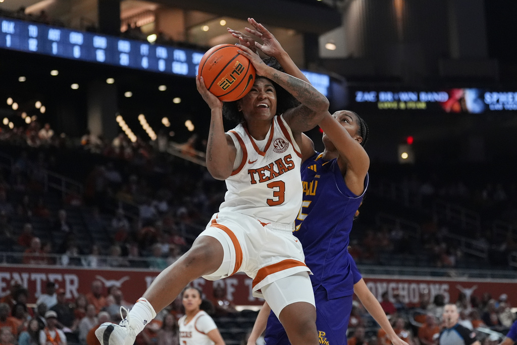 Texas guard Rori Harmon (3) drives to the basket against Prairie View A&M center Preston Young (15) during the second half of an NCAA college basketball game in Austin, Texas, Sunday, Dec. 7, 2025. (AP Photo/Eric Gay)
