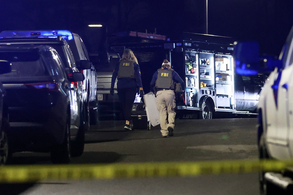 Law enforcement officers are seen outside a storage facility where a suspect in the shooting at Brown University was found dead, Thursday, Dec. 18, 2025, in Salem, N.H. (AP Photo/Reba Saldanha)