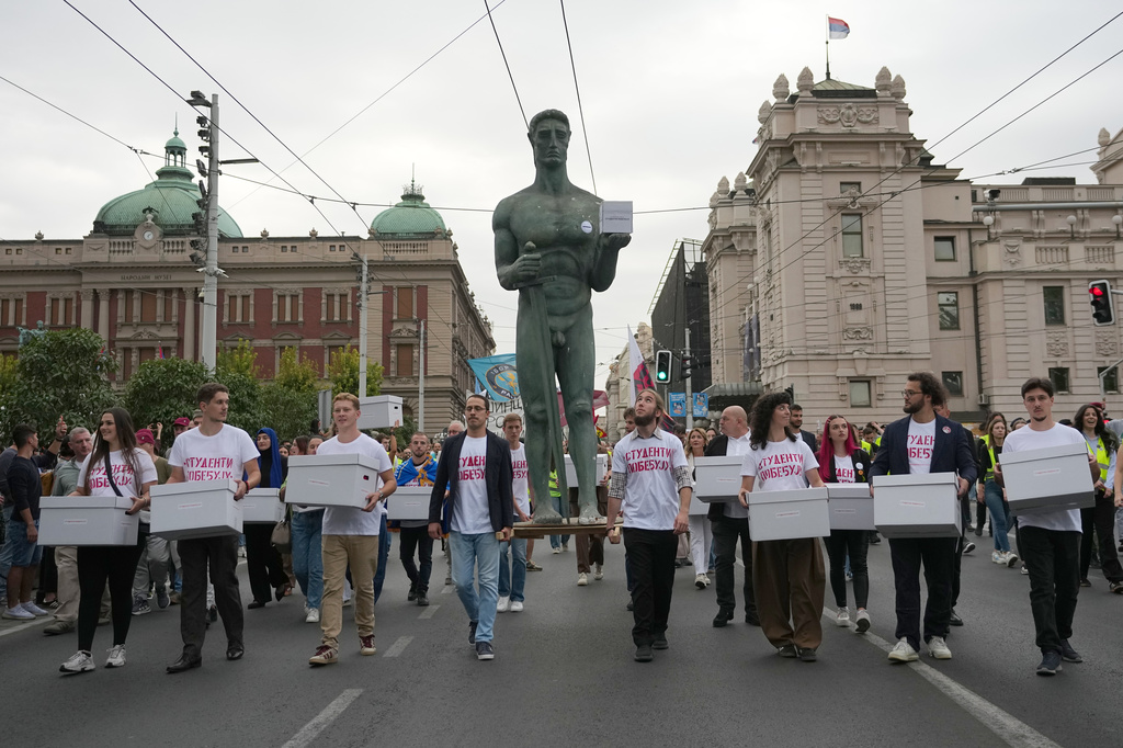 Political candidates, students and citizens carry signatures for the "Student list - Students win" to the Republic Election Commission towards participation in the upcoming parliamentary elections in Belgrade, Serbia, Monday, Sept. 14, 2026. (AP Photo/Darko Vojinovic)