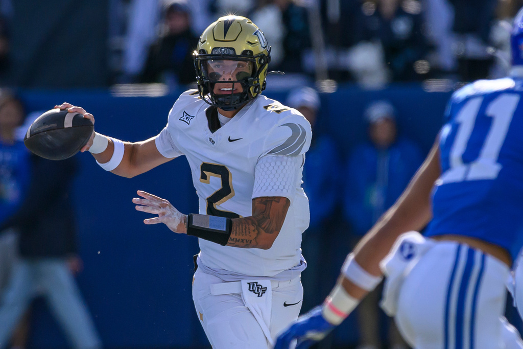 UCF quarterback Tayven Jackson looks the throw the ball during the first half an NCAA college football game against BYU, Saturday, Nov. 29, 2025, in Provo, Utah. (AP Photo/Tyler Tate)