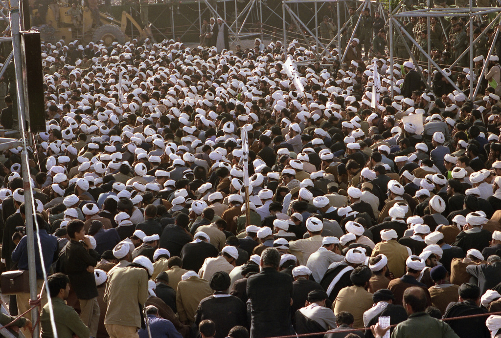 FILE - Mourners crowd around the grave of the late Ayatollah Khomeini at the cemetery in Beheshte e Zahra, some 70 kms from Tehran, Iran, June 11, 1989. (AP Photo/Heribert Proepper, File)