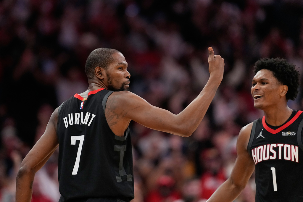 Houston Rockets' Kevin Durant (7) celebrates with Amen Thompson (1) after making a game-winning 3-point basket against the Phoenix Suns during the second half of an NBA basketball game Monday, Jan. 5, 2026, in Houston. (AP Photo/David J. Phillip)