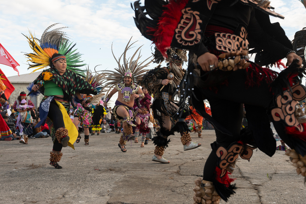 Aztec dancers perform during a sunrise gathering on Indigenous Peoples Day on Alcatraz Island on Monday, Oct. 13, 2025, in San Francisco. (AP Photo/Laure Andrillon)