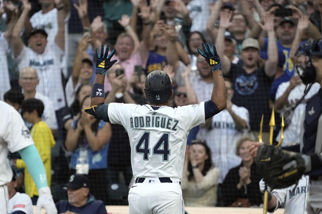 Seattle Mariners' Julio Rodriguez (44) reacts with fans above the dugout after he hit a solo home run against the Tampa Bay Rays during the third inning of a baseball game, Saturday, Aug. 9, 2025, in Seattle. (AP Photo/Ted S. Warren)