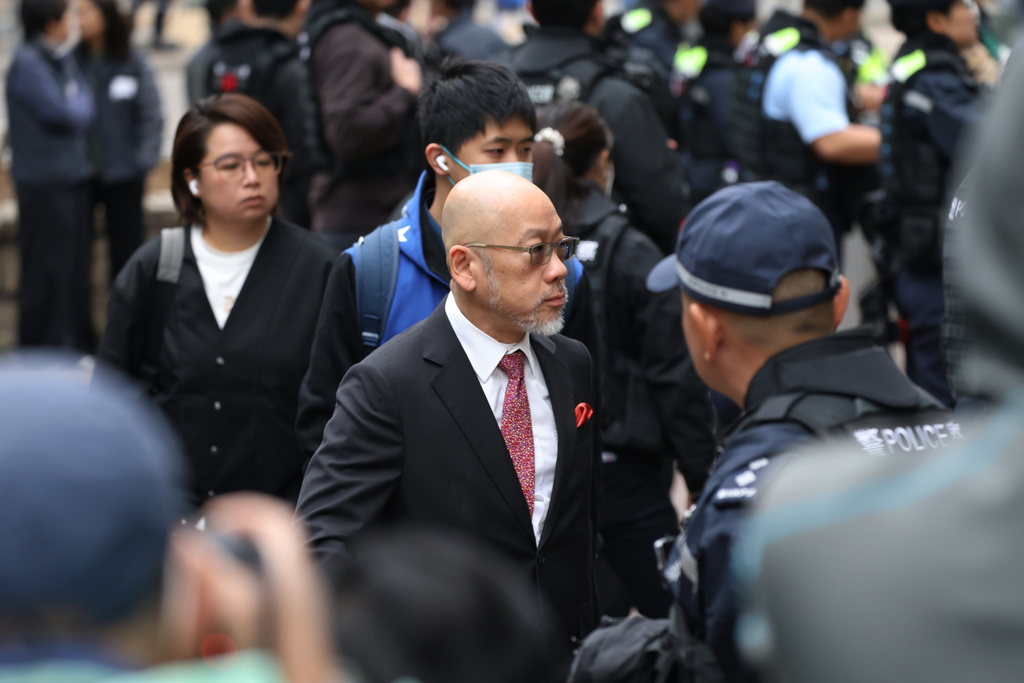 Robert Pang, center, lawyer for pro-democracy media mogul Jimmy Lai arrives to the West Kowloon Magistrates' Courts, ahead of a hearing to hear arguments about the sentencing of Lai, in Hong Kong, Monday, Jan. 12, 2026. (AP Photo/May James)