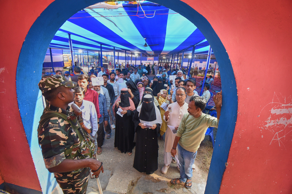 People stand in a queue to cast their votes for Bihar state election at a polling booth in Patna, India, Thursday, Nov. 6, 2025. (AP Photo)