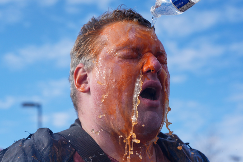 A protester's face is doused in water after he was pepper sprayed outside of the Bishop Whipple Federal Building, Monday, Jan. 12, 2026, in Minneapolis. (AP Photo/Jen Golbeck)