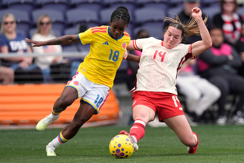Canada defender Vanessa Gilles (14) kicks the ball away from Colombia midfielder Linda Caicedo (18) during the second half of a SheBelieves Cup women's soccer tournament match Sunday, March 1, 2026, in Nashville, Tenn. (AP Photo/George Walker IV)