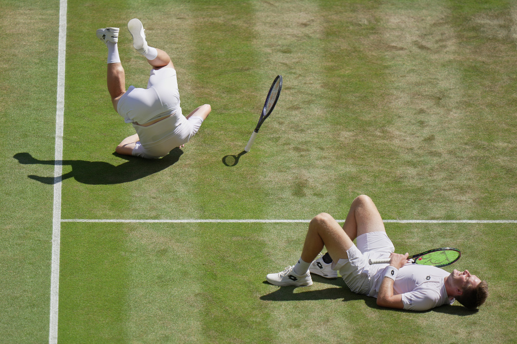 Harri Heliovaara of Finland, left and playing partner Henry Patten of Britain react after defeating Marcelo Arevalo of El Salvador, and Mate Pavic of Croatia, in the men's doubles final at Wimbledon Tennis Championships in London, Saturday, July 11, 2026. (AP Photo/Brian Inganga) CORRECTION: Corrects the second name of Henry and the nationality of Marcelo Arevalo.
