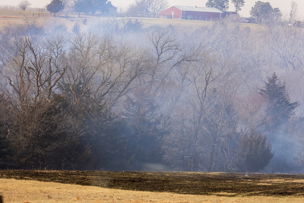 Malcolm and Lincoln firefighters respond to a wildfire in Denton, Neb., on Thursday, March 12, 2026. (Kenneth Ferriera/Omaha World-Herald via AP)