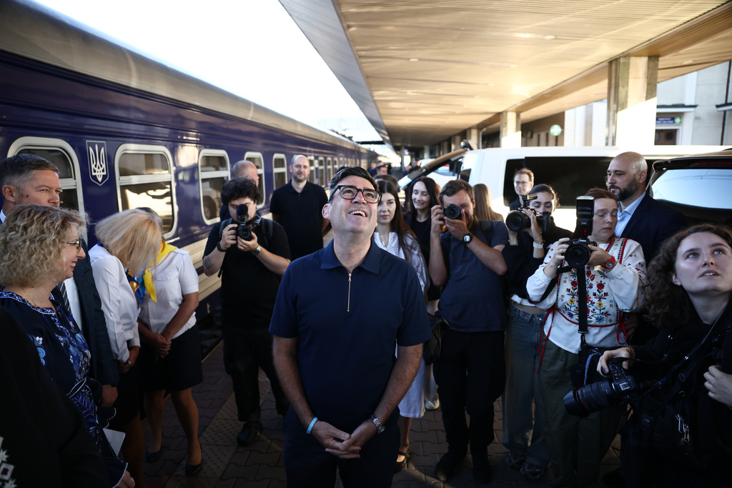 Britain's prime minister Andy Burnham, centre, smiles upon his arrival by train, in Kyiv, Monday, Aug. 24, 2026. (Henry Nicholls/Pool Photo via AP)