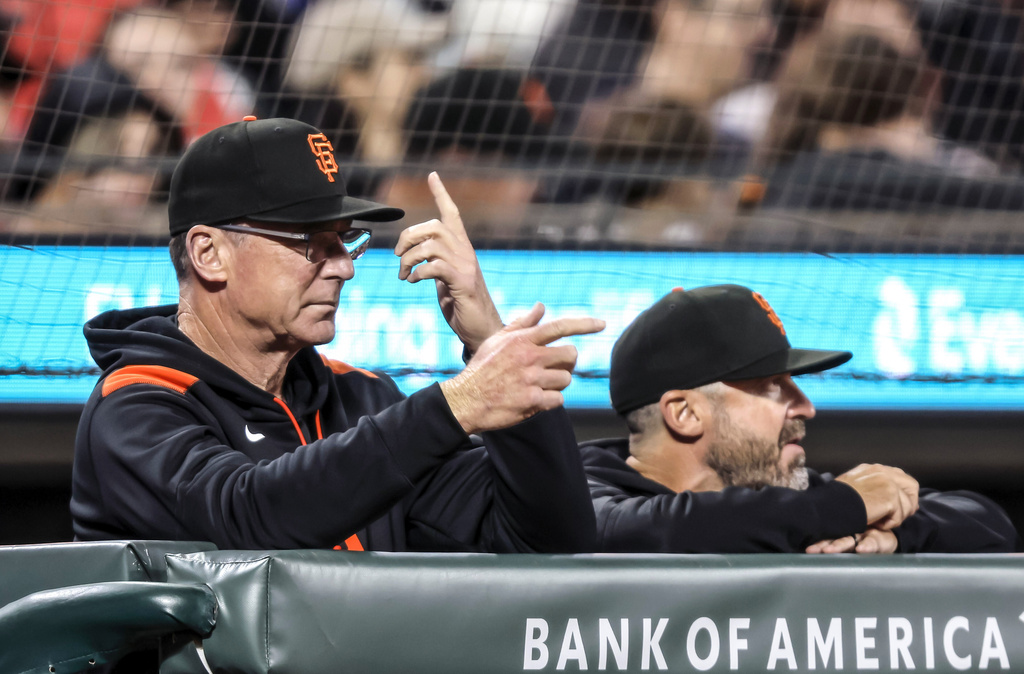 San Francisco Giants manager Bob Melvin signals to batter Casey Schmitt (10) in the fourth inning of a baseball game against the St. Louis Cardinals at Oracle Park in San Francisco, on Monday, Sept. 22, 2025. (Carlos Avila Gonzalez/San Francisco Chronicle via AP)