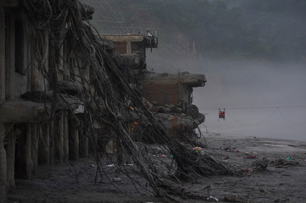 Residents commute across the Trishuli river on a newly installed zipline in the aftermath of flash floods in Devighat, Nuwakot district, Nepal, Monday, Sept. 7, 2026. (AP Photo/Niranjan Shrestha)