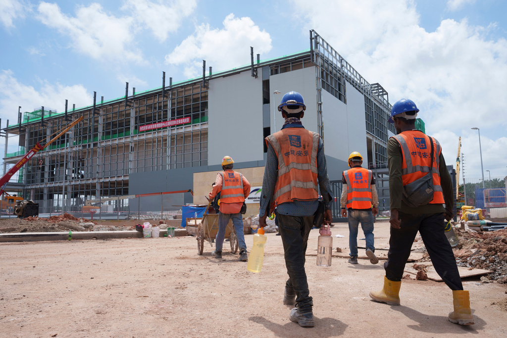 FILE -Construction workers walk to a data center building under construction in Sedenak Tech Park in Johor state of Malaysia, Sept. 27, 2024. (AP Photo/Vincent Thian, File)