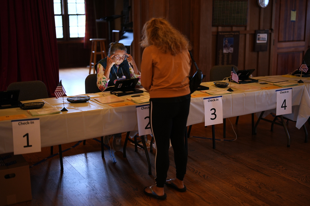 A voter checks in at a polling station on Tuesday, Nov. 4, 2025, in Del Mar, Calif. (AP Photo/Gregory Bull)