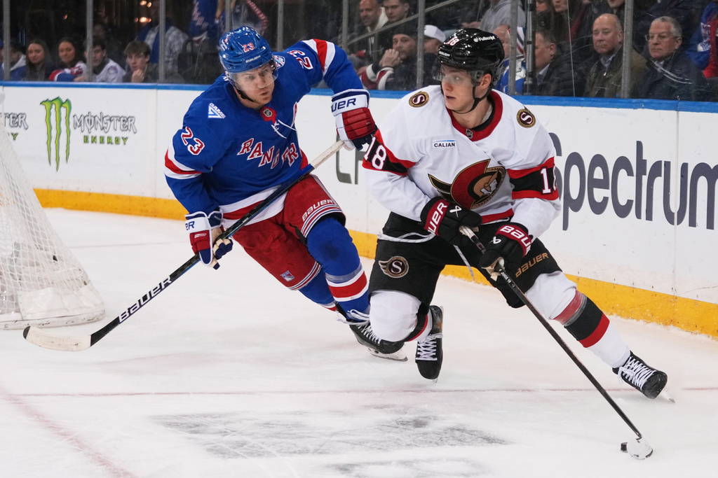 New York Rangers' Adam Fox (23) defends Ottawa Senators' Tim Stützle (18) during the third period of an NHL hockey game Monday, March 23, 2026, in New York. (AP Photo/Frank Franklin II)