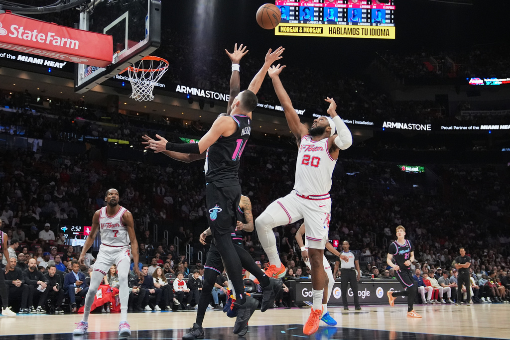 Miami Heat guard Tyler Herro (14) shoots over Houston Rockets guard Josh Okogie (20) during the first half of an NBA basketball game, Saturday, Feb. 28, 2026, in Miami. (AP Photo/Lynne Sladky)