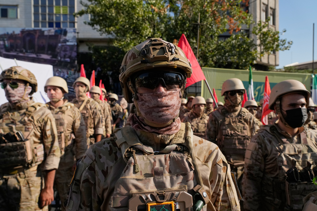 Armed personnel affiliated with Iran's Revolutionary Guard take part in the state-organized "Janfada," or "Sacrifice for Iran," military exercise in Tehran, Iran, Friday, Sept. 18, 2026. (AP Photo/Vahid Salemi)