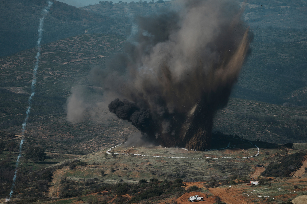 A huge explosion erupts during a live-fire exercise near the northeastern city of Alexandroupolis, Greece, testing domestically-developed drones and counter-drone systems as part of NATO's modernization efforts on Friday, Nov. 14, 2025. (AP Photo/Thanassis Stavrakis)
