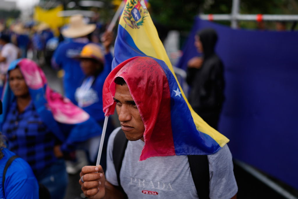 Government supporters gather for a rally marking the anniversary of the Battle of Santa Ines, which took place during Venezuela's 19th-century Federal War, in Caracas, Venezuela, Wednesday, Dec. 10, 2025. (AP Photo/Ariana Cubillos)