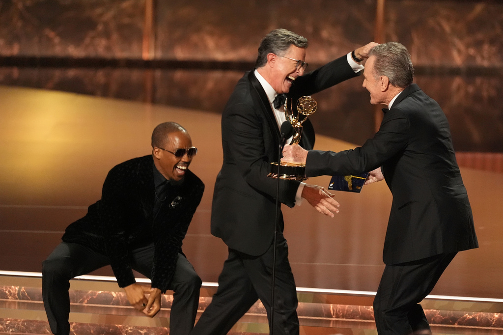 FILE - Bryan Cranston, right, presents the award for outstanding talk series to Stephen Colbert, left, for "The Late Show with Stephen Colbert" during the 77th Primetime Emmy Awards in Los Angeles on Sept. 14, 2025. (AP Photo/Chris Pizzello, File)