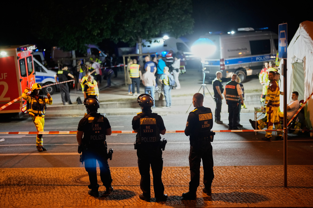 Emergency personnel and police gather in Berlin, early Sunday, July 26, 2026, following the cancellation of Christopher Street Day festivities. (AP Photo/Ebrahim Noroozi)