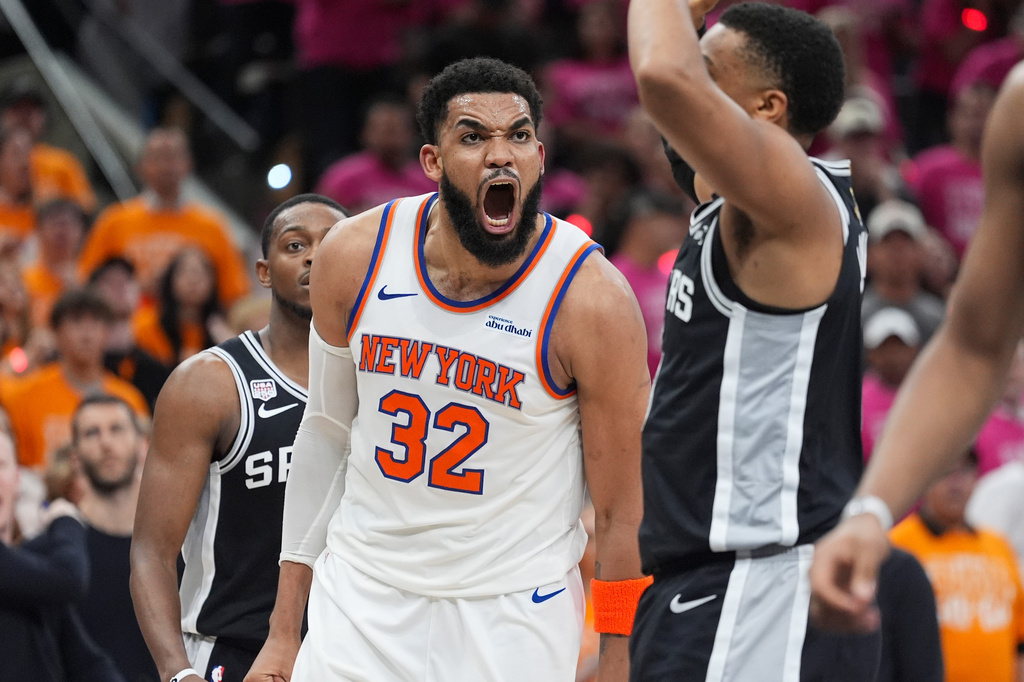 New York Knicks center Karl-Anthony Towns (32) yells during the second half of Game 1 of the NBA Finals basketball series against the San Antonio Spurs, Wednesday, June 3, 2026, in San Antonio. (AP Photo/Eric Gay)